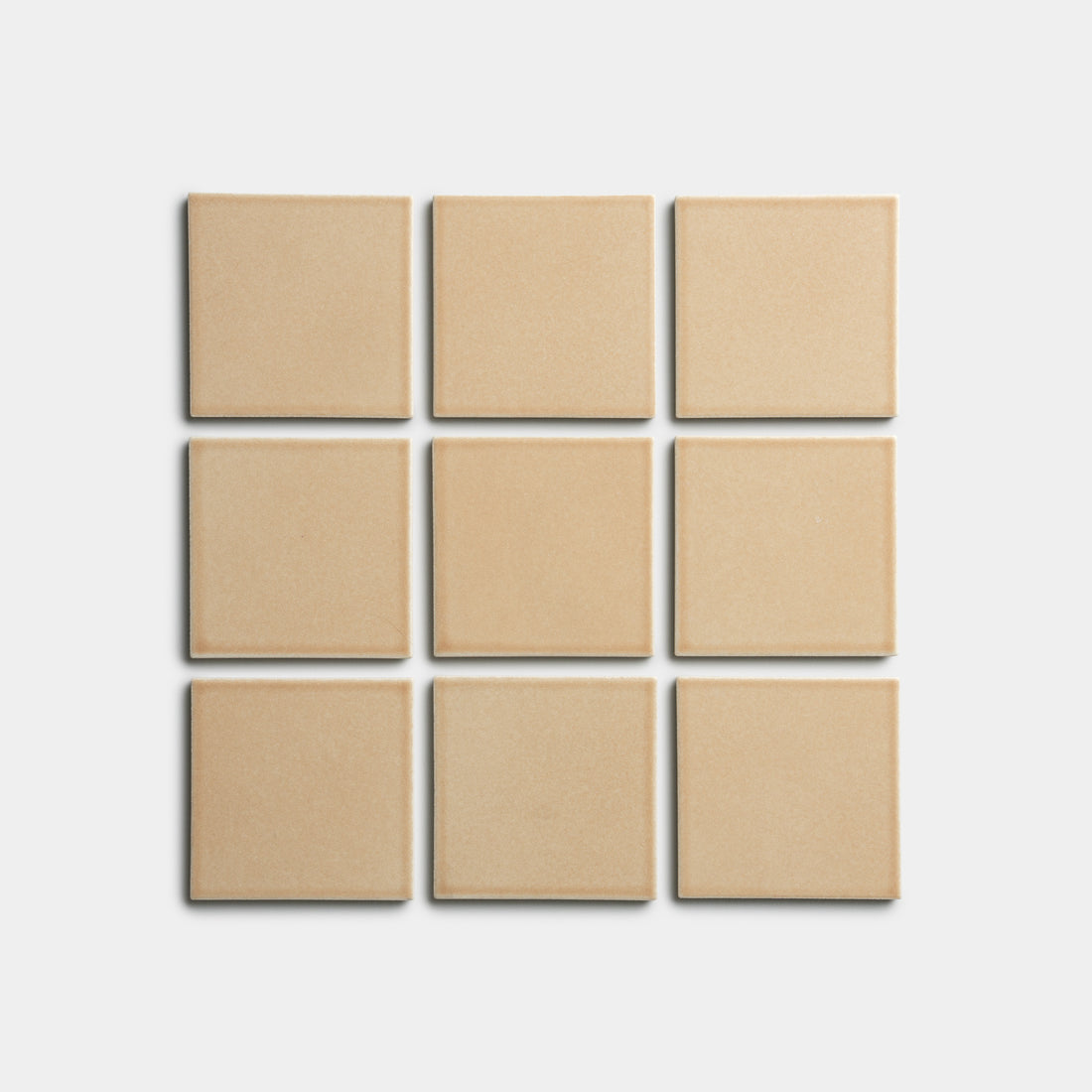 Nine Biscuit 4x4 square tiles by Zia Tile, in beige, arranged in a 3x3 grid on a plain white background.