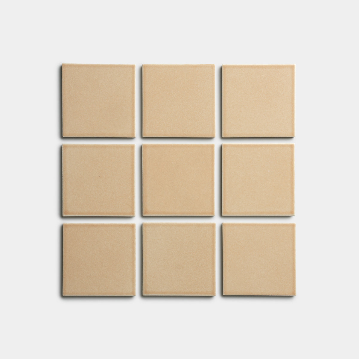 Nine Biscuit 4x4 square tiles by Zia Tile, in beige, arranged in a 3x3 grid on a plain white background.