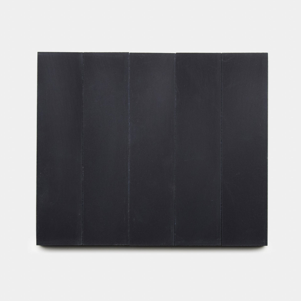 A minimalist rectangular artwork with five vertical, equally sized Black 2x8 tiles by Zia Tile, set side by side on a white background, evoking handmade tile designs.