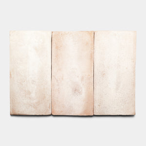 Three rectangular, light beige clay tiles with subtle texture and slight variations in color are arranged side by side against a plain white background.