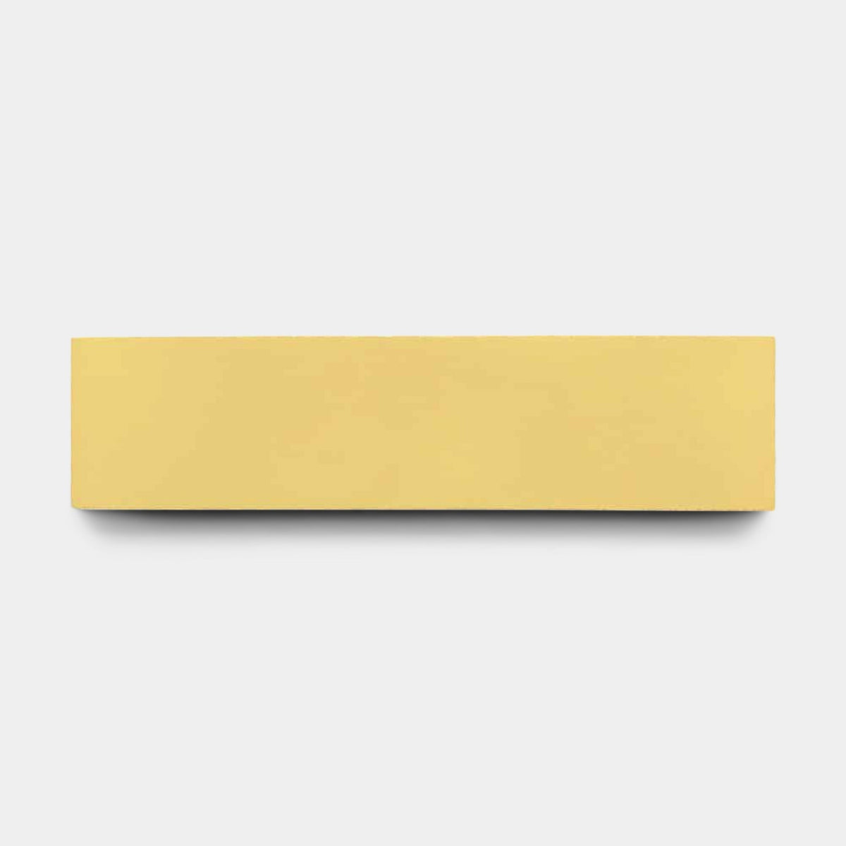 The Blonde 4x4, Sample by vendor-unknown is displayed centered against a plain light gray background, its rectangular solid yellow form echoing the smooth finish of a handmade tile.