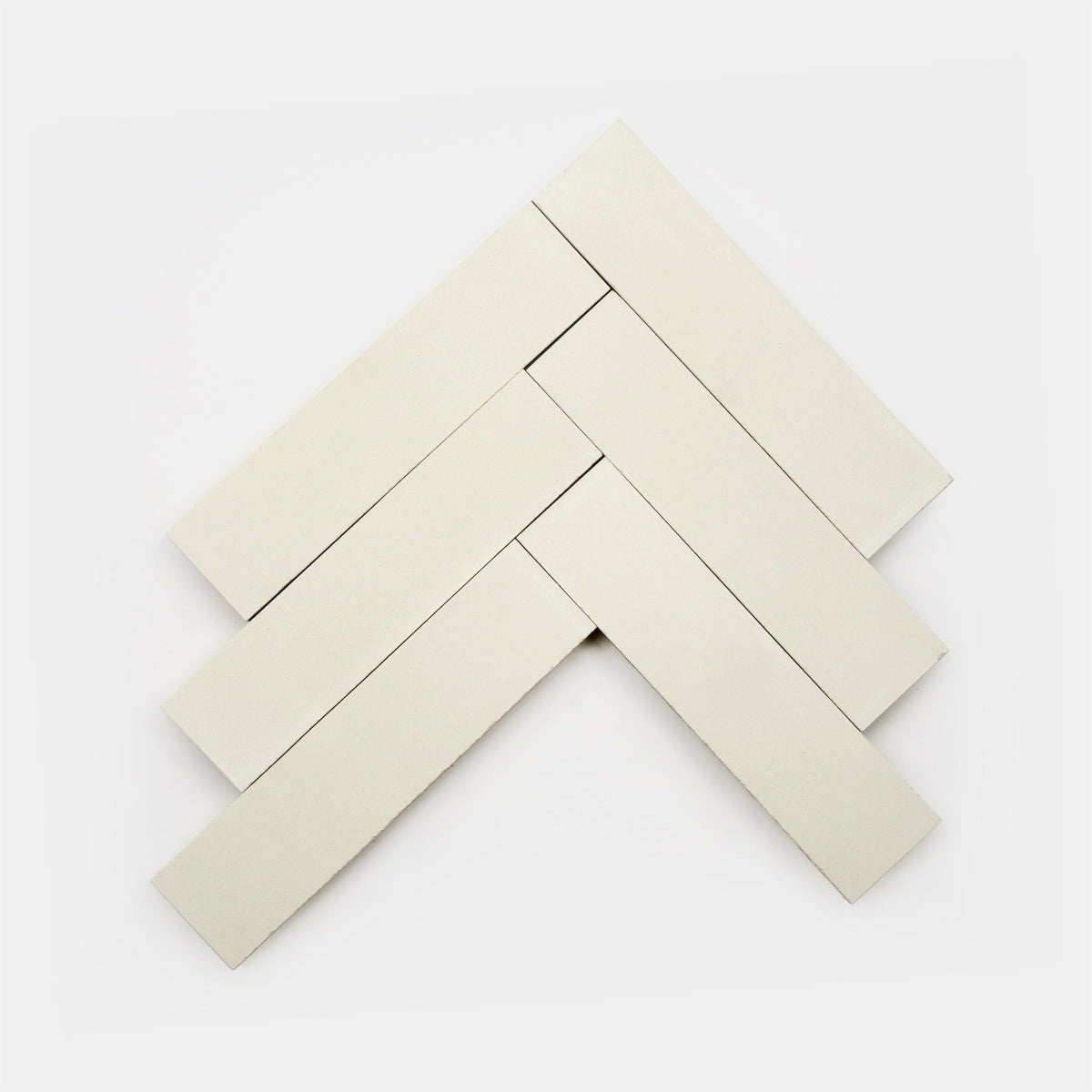 Five rectangular Bonsai 2x8 tiles from Zia Tile are arranged in a herringbone pattern on a plain white background.