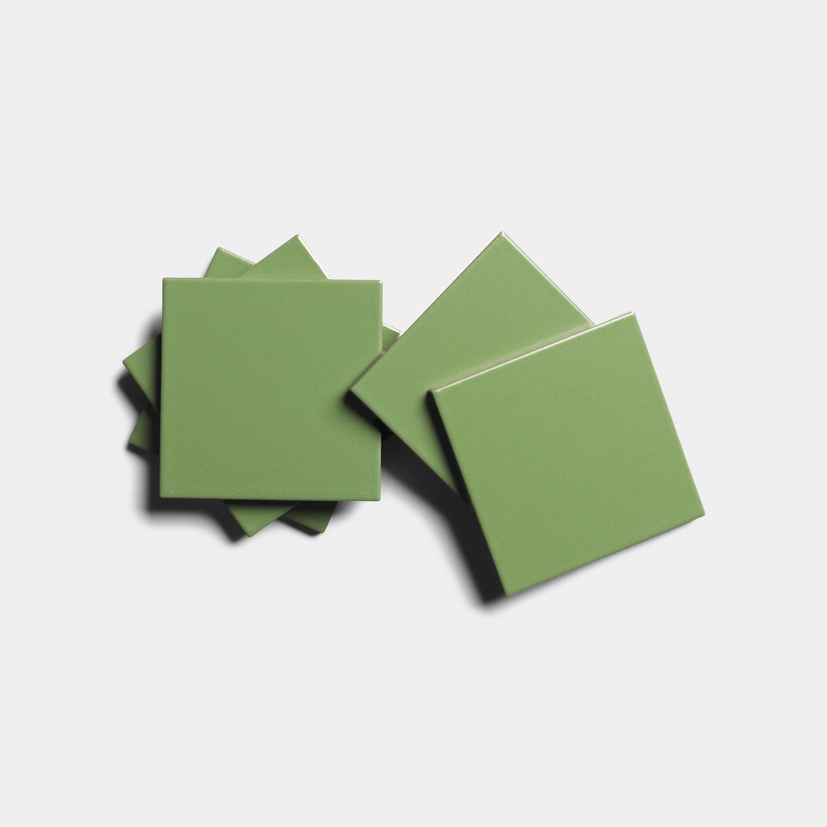 Five glossy, square Bonsai 4x4 cement tile samples from Zia Tile are arranged in a slightly overlapping pattern on a plain white background.