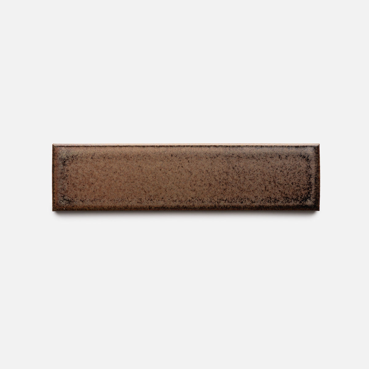 The Buckeye + Flat, Sample by Zia Tile is a rectangular brown ceramic tile with a speckled, subtly textured surface, shown against a plain white background.