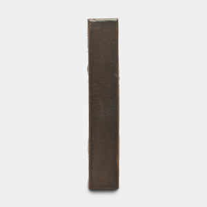 The Cacao Mini Bar by Zia Tile is a rectangular, upright dark brown-bronze metal bar shown against a plain white background, viewed from its narrow side.