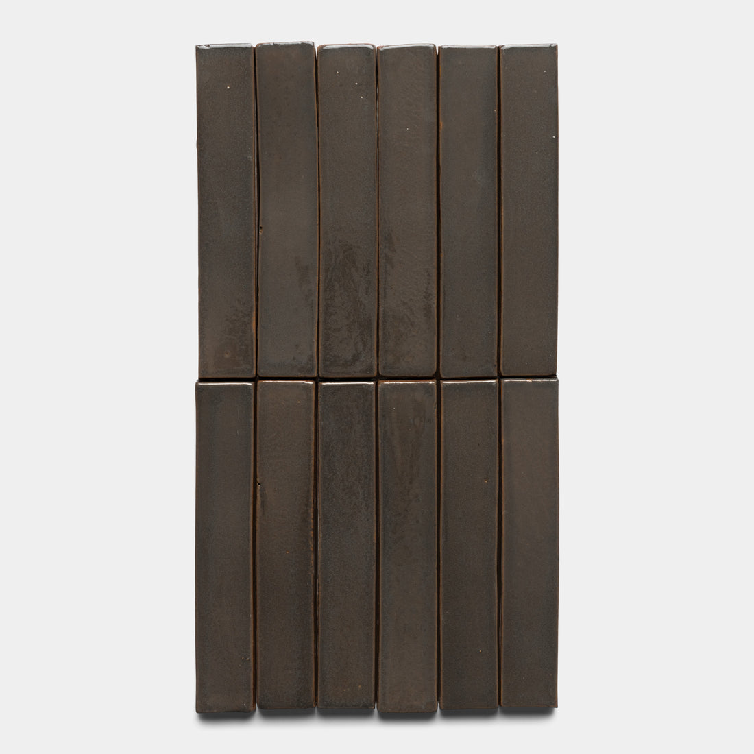 Twelve Zia Tile Cacao Mini Bar dark brown rectangular boxes are stacked in two vertical rows of six against a plain white background.