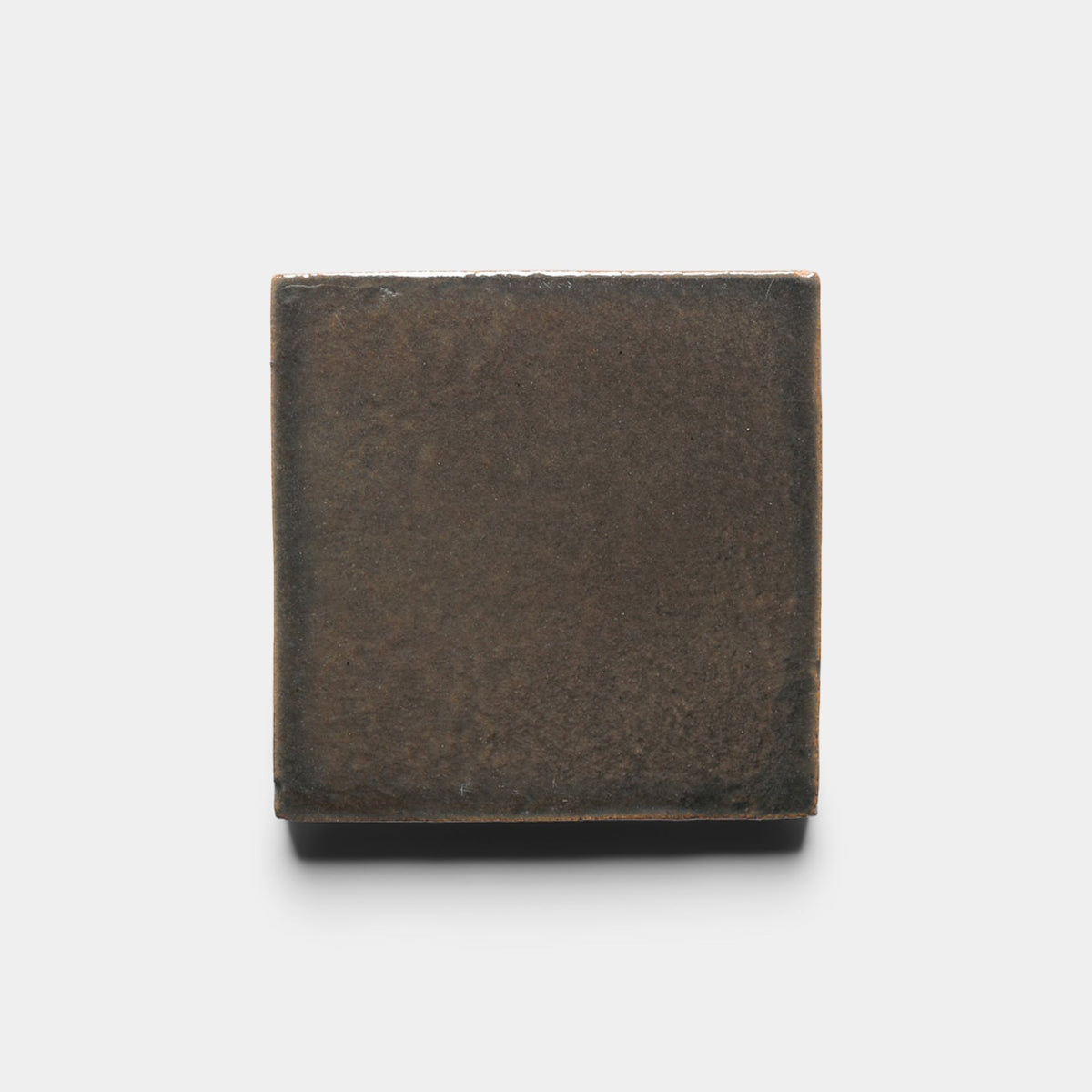 A single Cacao 4x4 Square tile sample by Zia Tile, dark brown with a slightly textured surface, displayed against a plain white background.