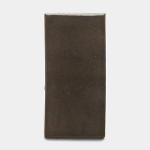 The Zia Tile Cacao 4x8 Rectangle is a ceramic tile featuring a smooth, matte dark brown finish and softly rounded edges, shown against a plain white background.