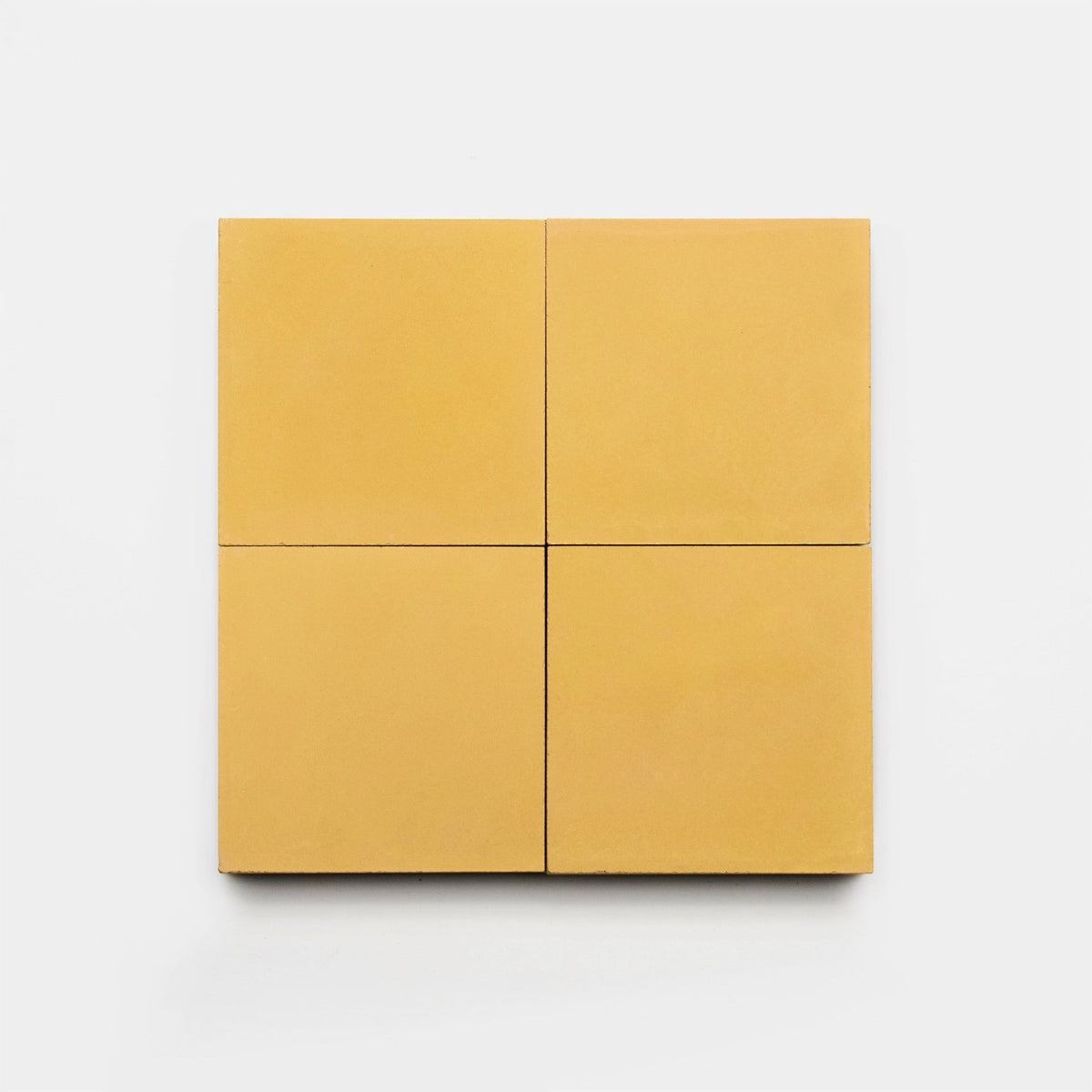 Four Cadmium 2x6 tiles from Zia Tile, in a bold mustard-yellow shade, are displayed in a 2x2 grid on a plain white background.