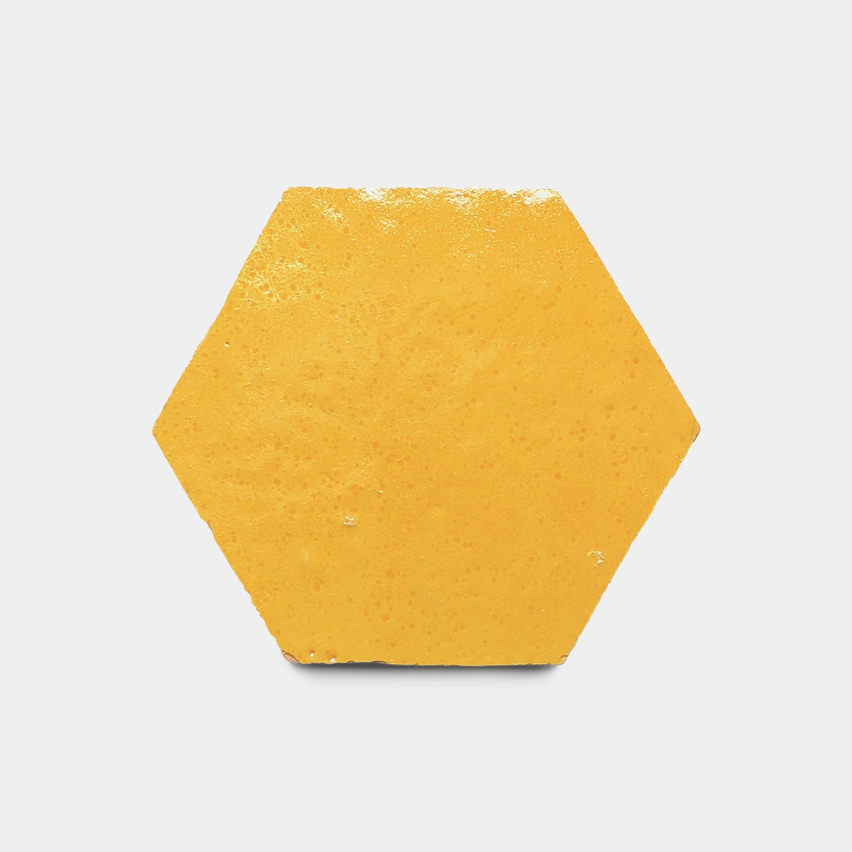 A single Cadmium Hex, Sample tile by Zia Tile—yellow, hexagonal, handmade with a slightly textured surface—is centered on a plain white background.