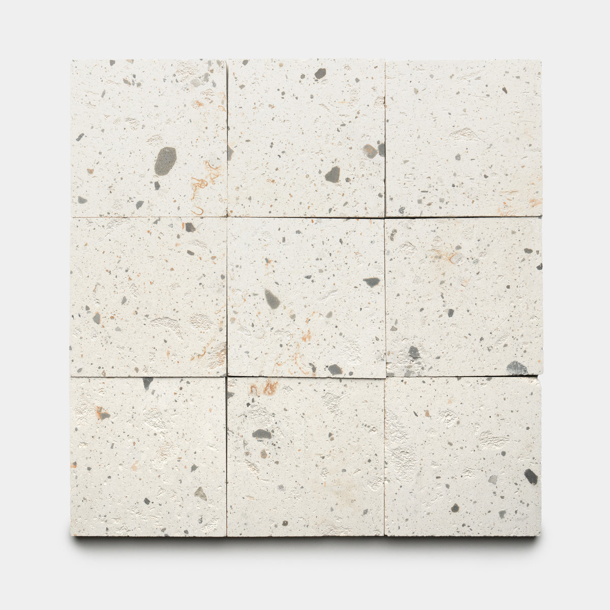 Nine Caldera 6x6 tiles by Zia Tile, off-white with subtle gray and brown speckles, are arranged in a 3x3 grid on a plain white background.