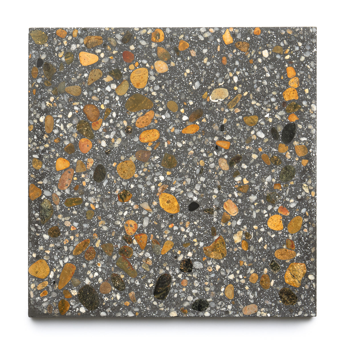 The Calypso 12x12 by Zia Tile is a handmade square terrazzo tile featuring a dark gray base with scattered yellow, orange, black, and white stone chips—drawing inspiration from Zia Tile’s cement tile collections.