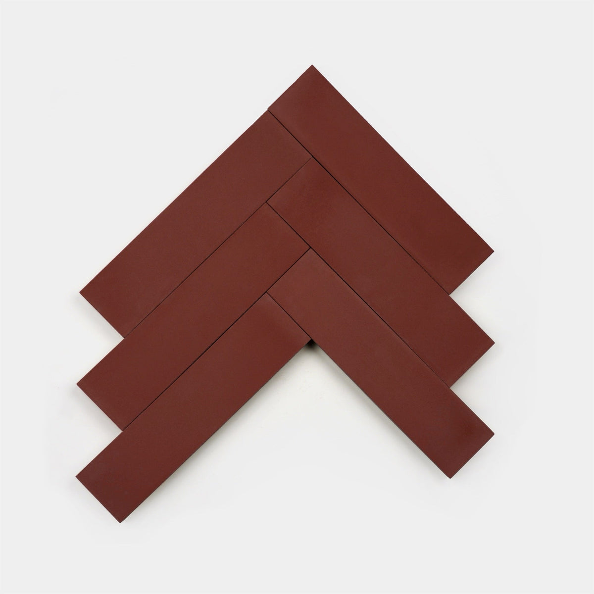 Five Canyon 2x8 rectangular, reddish-brown handmade tiles by vendor-unknown are arranged in a herringbone pattern, forming a chevron shape on a plain white background.