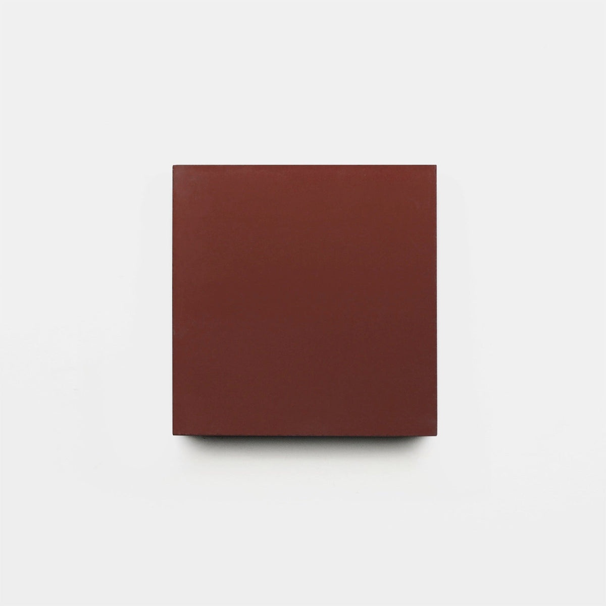 A Canyon 4x4 cement tile sample by vendor-unknown, featuring a plain solid reddish-brown color, is centered against a white background.