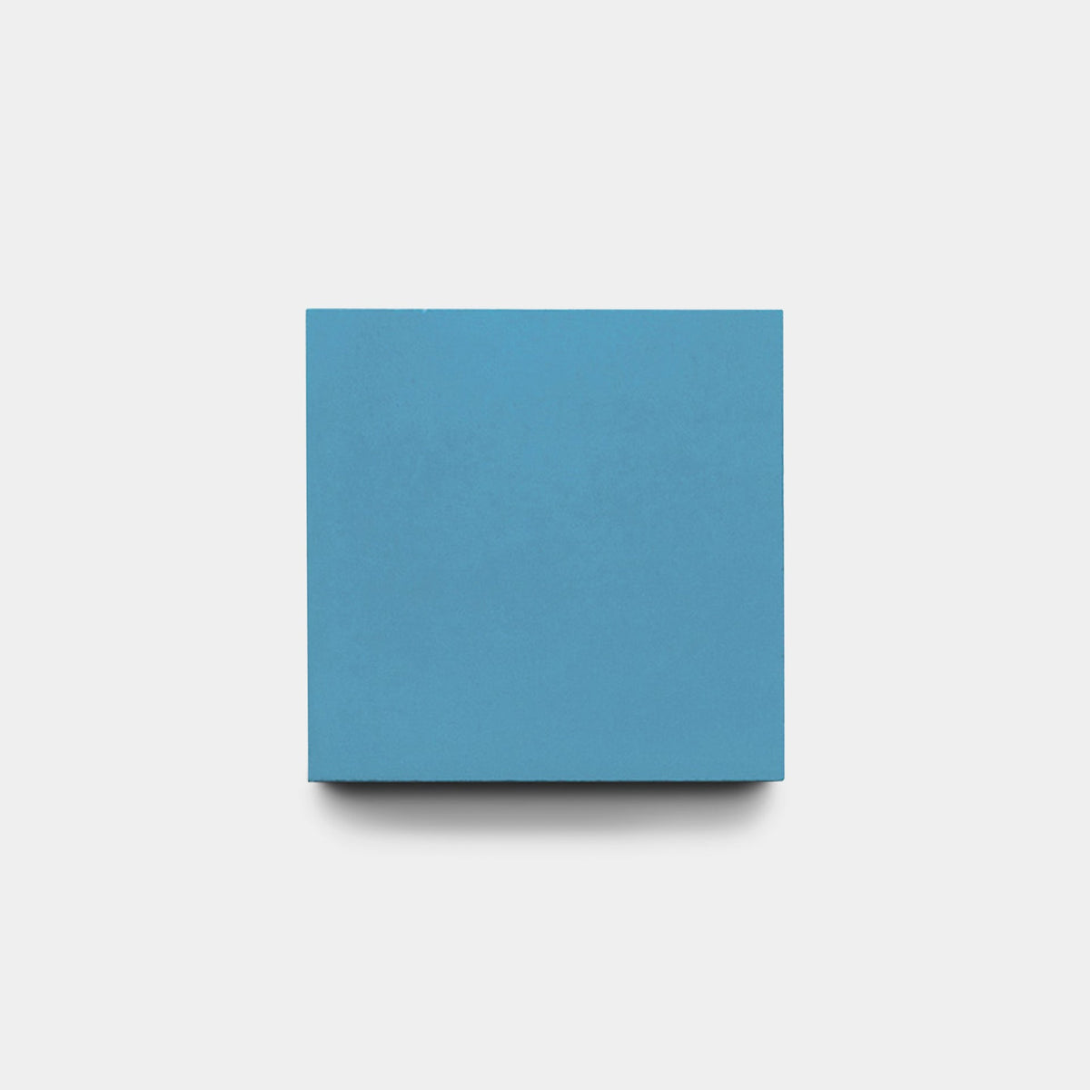 The Carolina Blue 8x8 Sample by vendor-unknown, a plain blue square reminiscent of handcrafted tile, is centered on a white background with a faint shadow below.