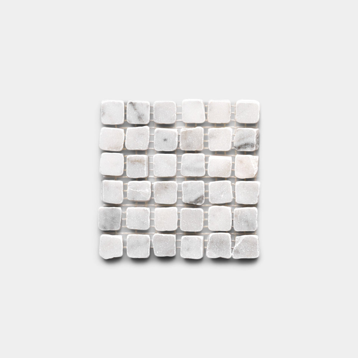 The Zia Tile Carrara 5/8 Sample features a square grid of small, rounded-edge white and light gray marble tiles set evenly against a light gray background.