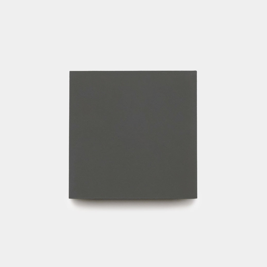 A closed, plain, dark gray square book is centered on a light gray background. The cover is blank with no text or images.