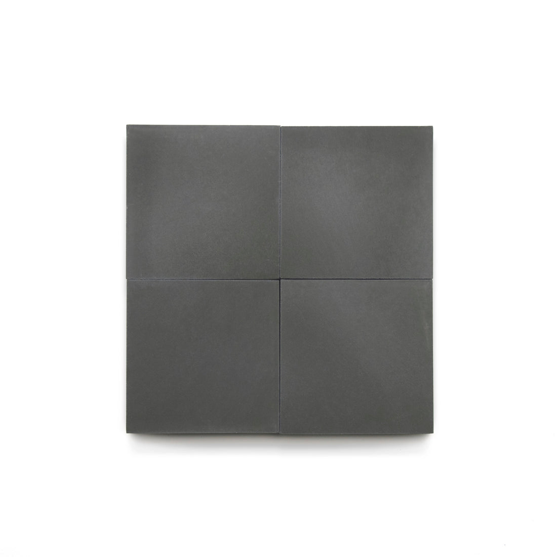 Four matte, dark gray Charcoal 4x4 tiles are arranged in a neat 2x2 grid on a plain white background, highlighting their modern look—ideal for bathroom floors or a stylish kitchen backsplash.