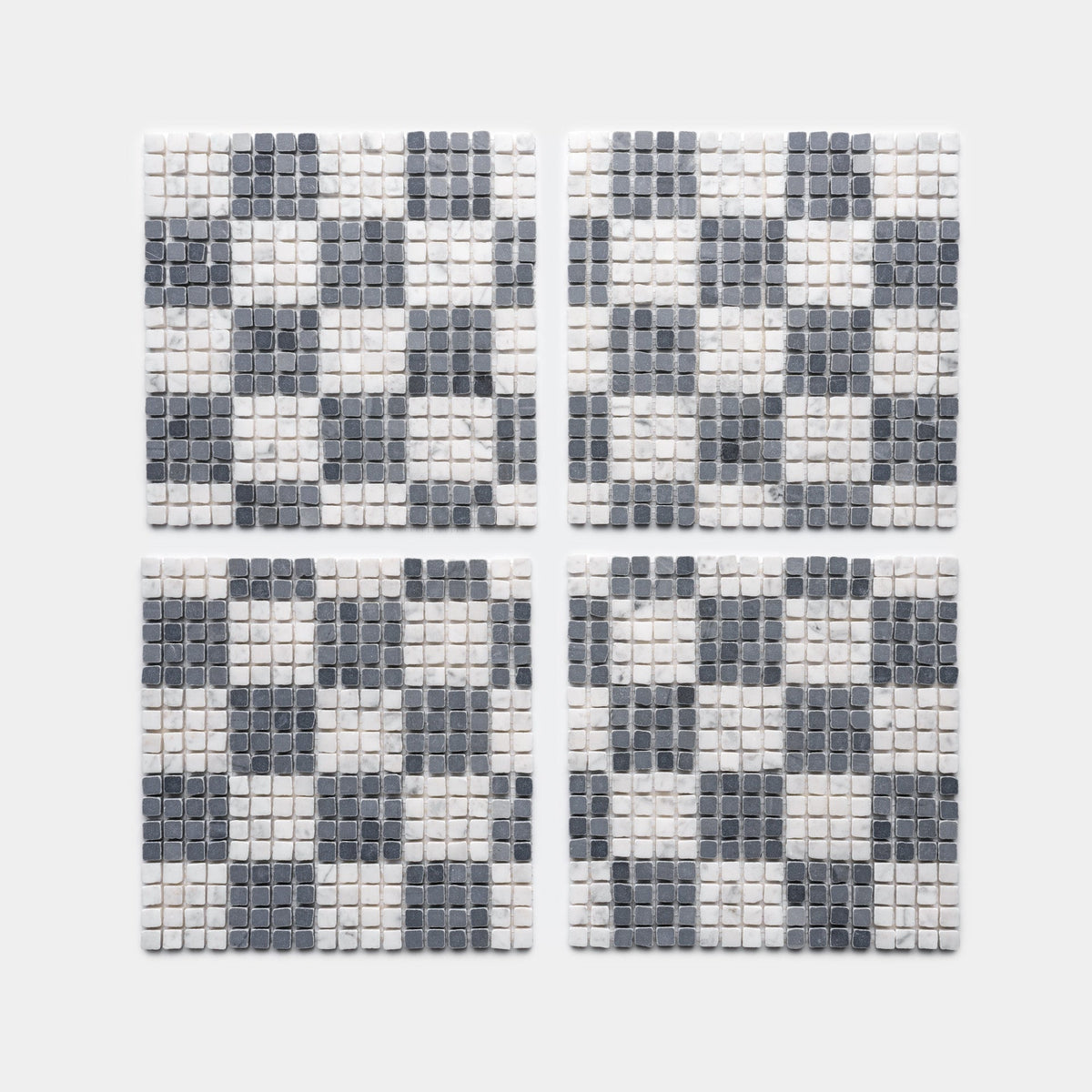 Four Check in Carrara + Bardiglio Imperiale square coasters by Zia Tile, featuring black, gray, and white tiles in a checkered pattern, shown arranged in a 2x2 grid on a light gray background.