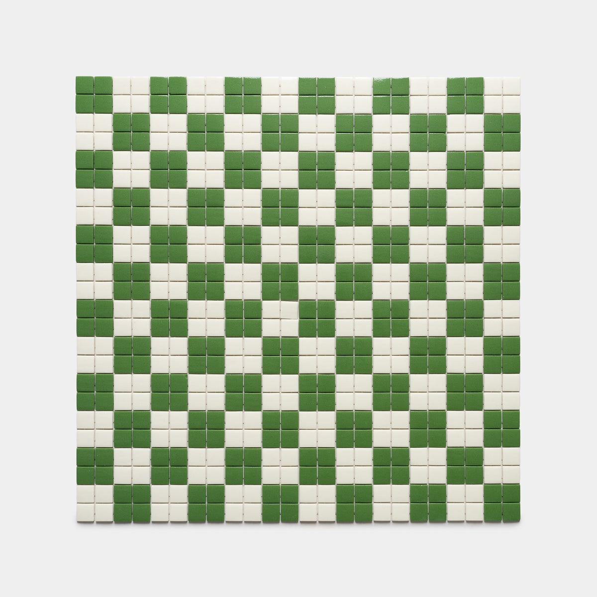 The Cheque Clover + Milk tile by Zia Tile is a square mosaic featuring a green and white checkerboard pattern on a white background.