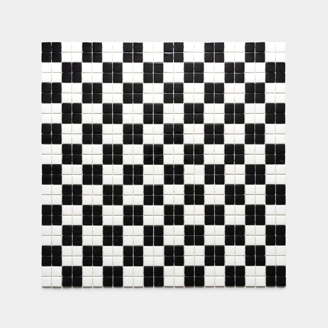 The Cheque Jet Black + Paperwhite tile by Zia Tile features a square pattern of alternating black and white tiles, creating a striking geometric grid of small black squares surrounded by white.