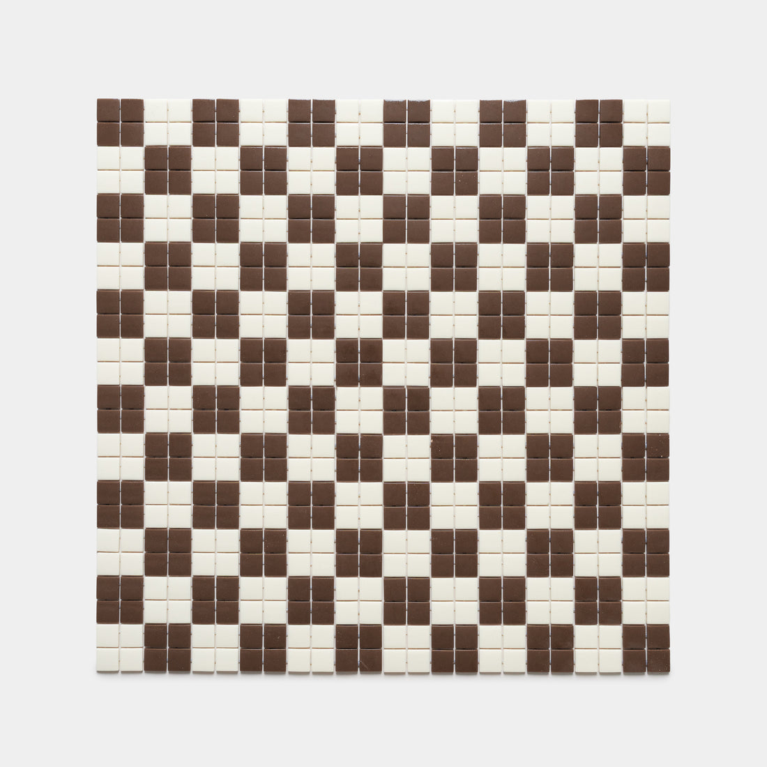 The Cheque Marmot + Milk tile by Zia Tile features a square grid of cream and brown tiles in a repeating geometric pattern, with clusters of four brown tiles creating a checkerboard effect on a cream background.