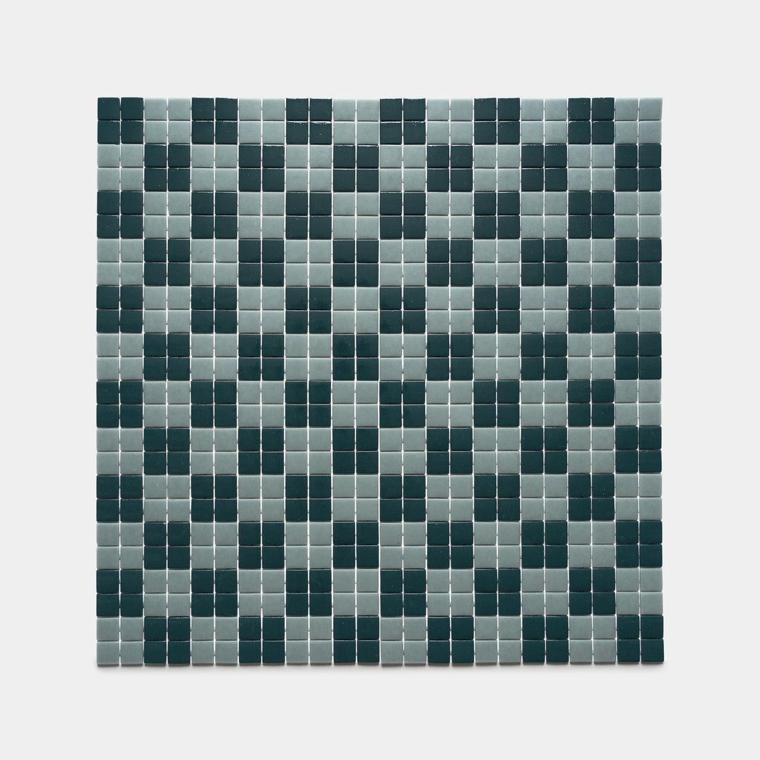 Zia Tile's Cheque Vespertine + Marine Layer features a grid of small square tiles in alternating dark green and light gray, forming a regular checkerboard pattern on a white background.