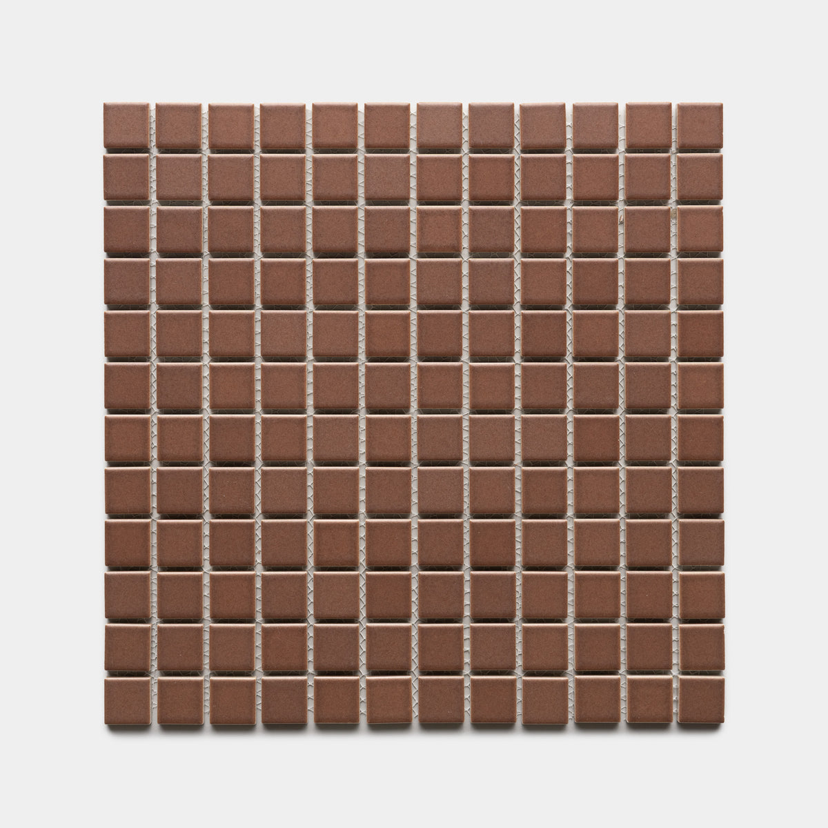 A square sheet of Zia Tile's Clove 1x1 tiles features small, evenly spaced brown ceramic squares arranged in a grid pattern on a white background.