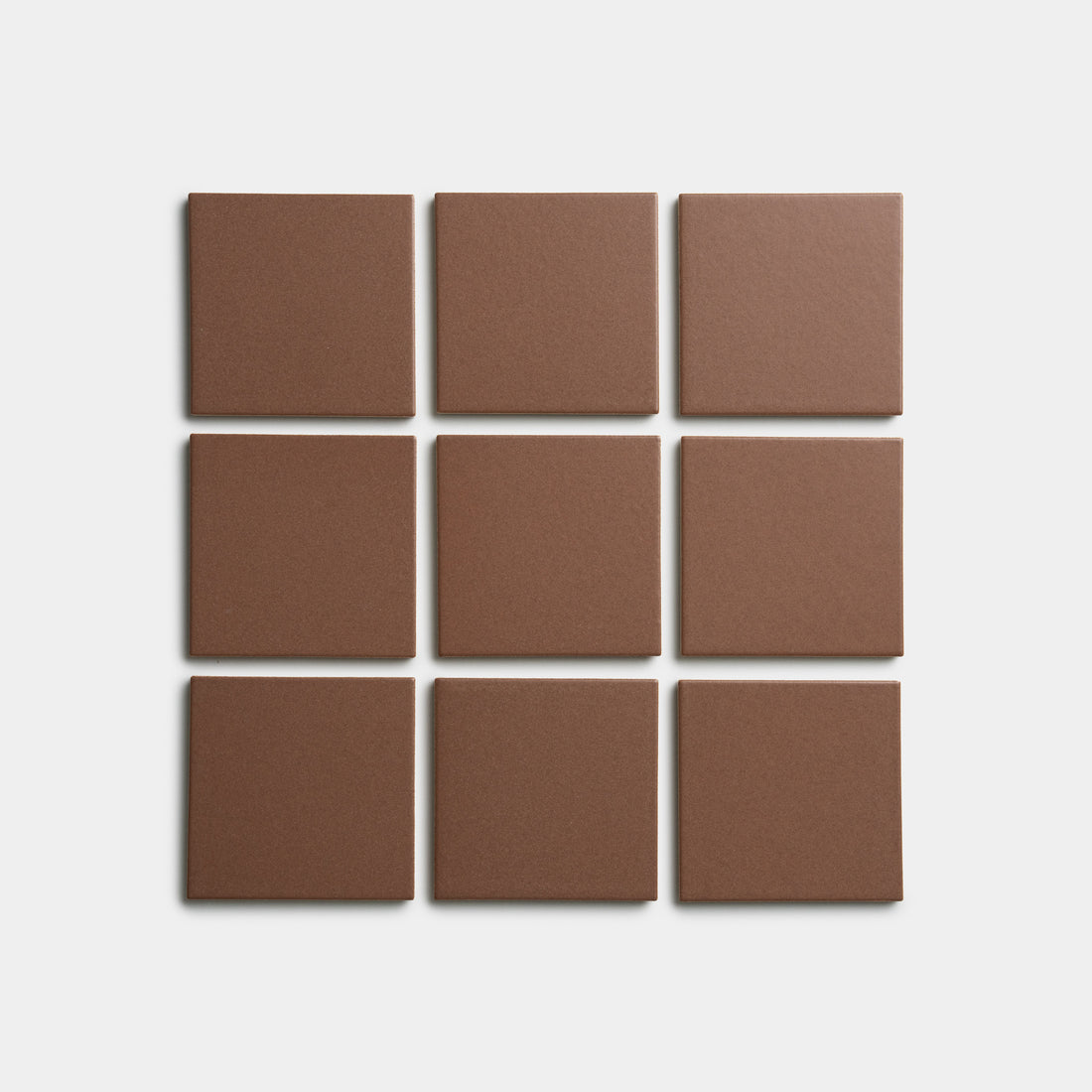 Nine Clove 4x4 brown square tiles by Zia Tile are arranged in a 3x3 grid on a plain white background.