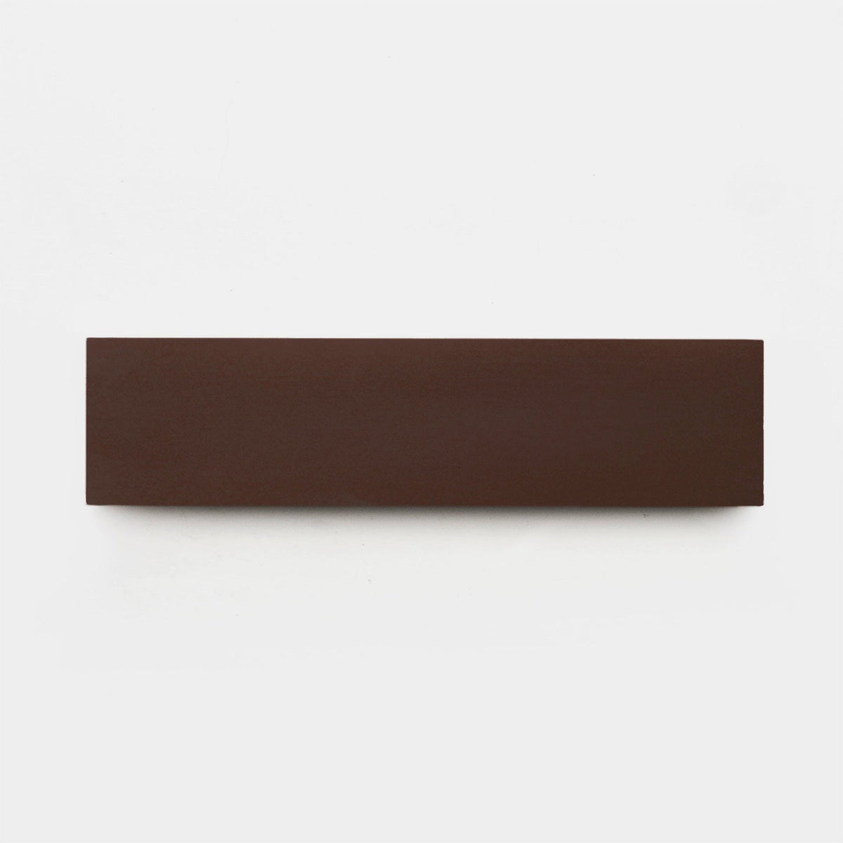 A rectangular, flat, dark brown handmade tile—Coffee 2x8, Sample by vendor-unknown—is centered on a plain white background.