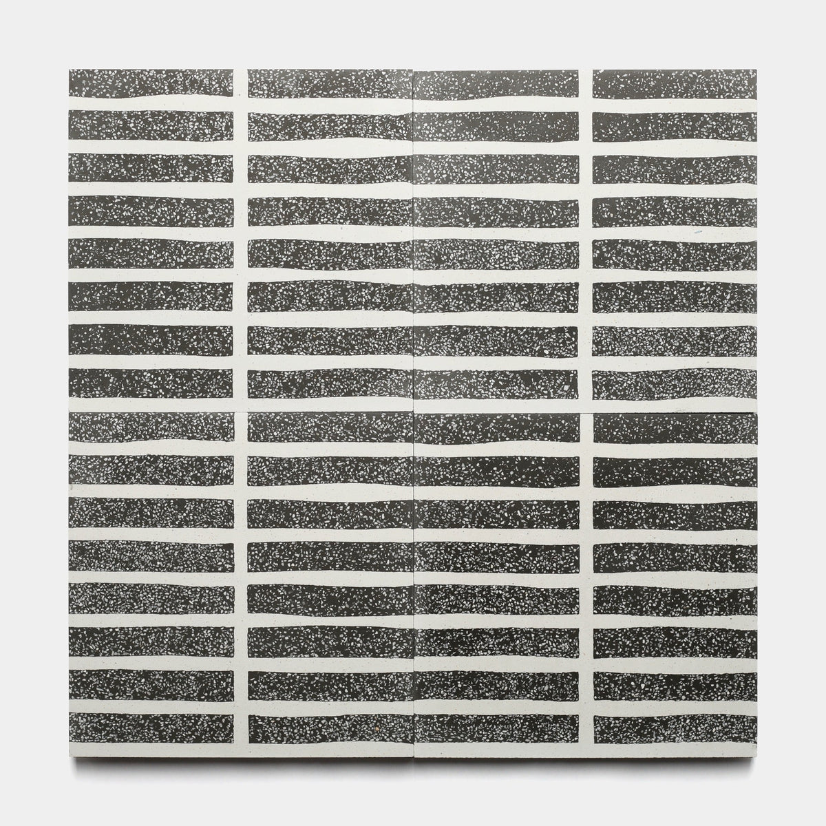 The Collins Ash 12x12 Sample by Zia Tile features black and white artwork with hand-drawn, irregular horizontal lines. Each row showcases small white dots on a black background, creating a grid pattern reminiscent of handmade tile.