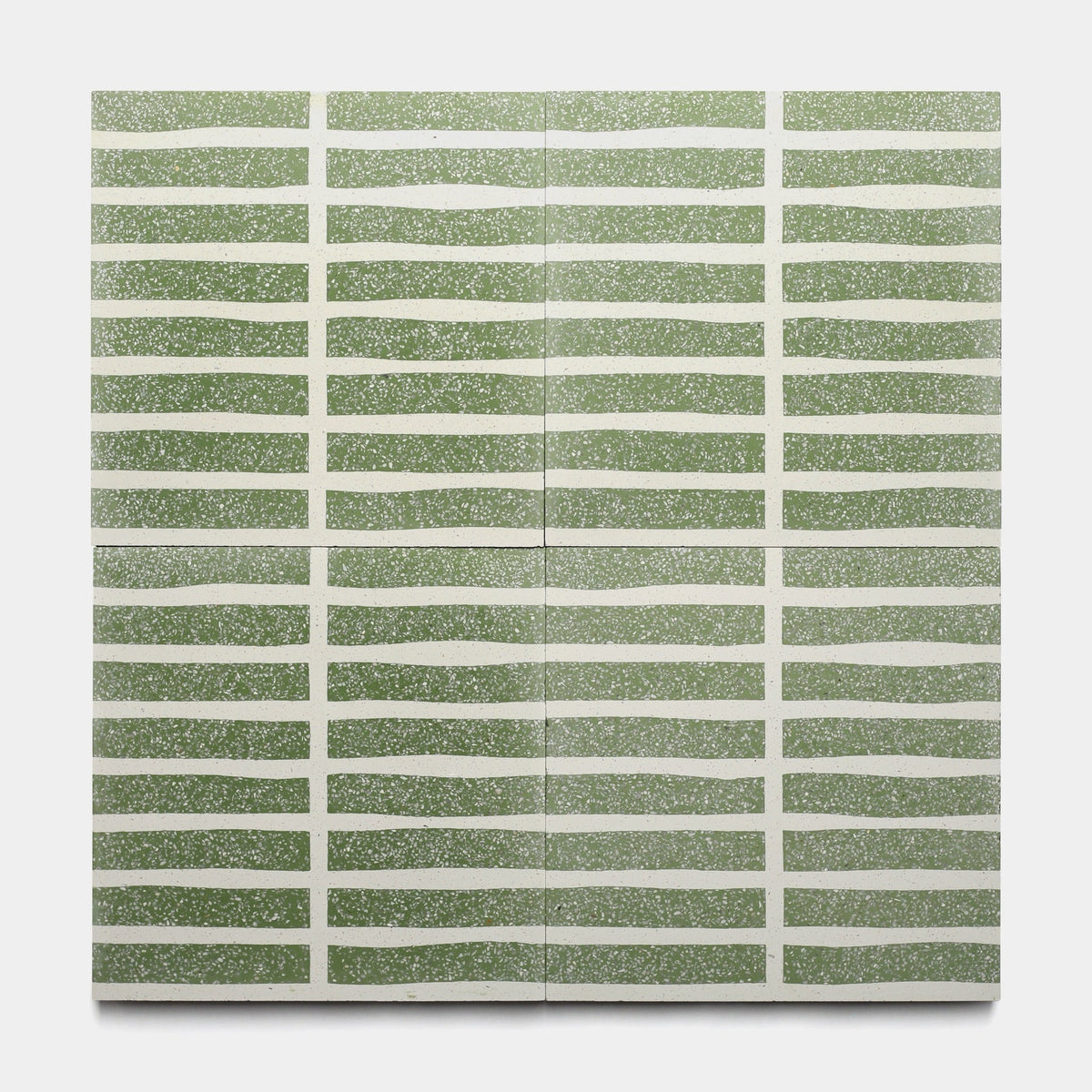 The Collins Saguaro 12x12 sample by Zia Tile features evenly spaced, wavy horizontal green lines with a speckled finish on white, creating a handmade cement tile look inspired by classic Zia Tile designs.