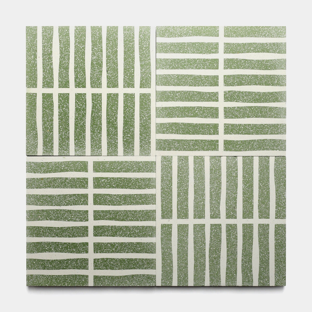 Four Collins Saguaro 12x12 samples by Zia Tile are arranged in a grid. With green backgrounds and white abstract lines, these tiles feature geometric, modern designs inspired by handmade cement tile with both wavy and straight patterns.