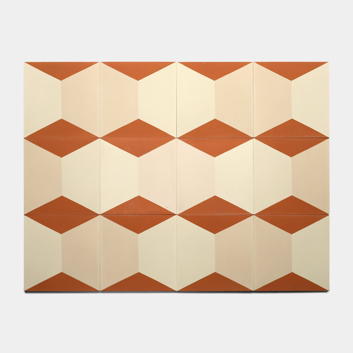 The Colorama Dune 8x8 Sample by Zia Tile showcases a geometric tile pattern with repeating 3D cubes in terracotta orange and cream, displayed on a plain background.