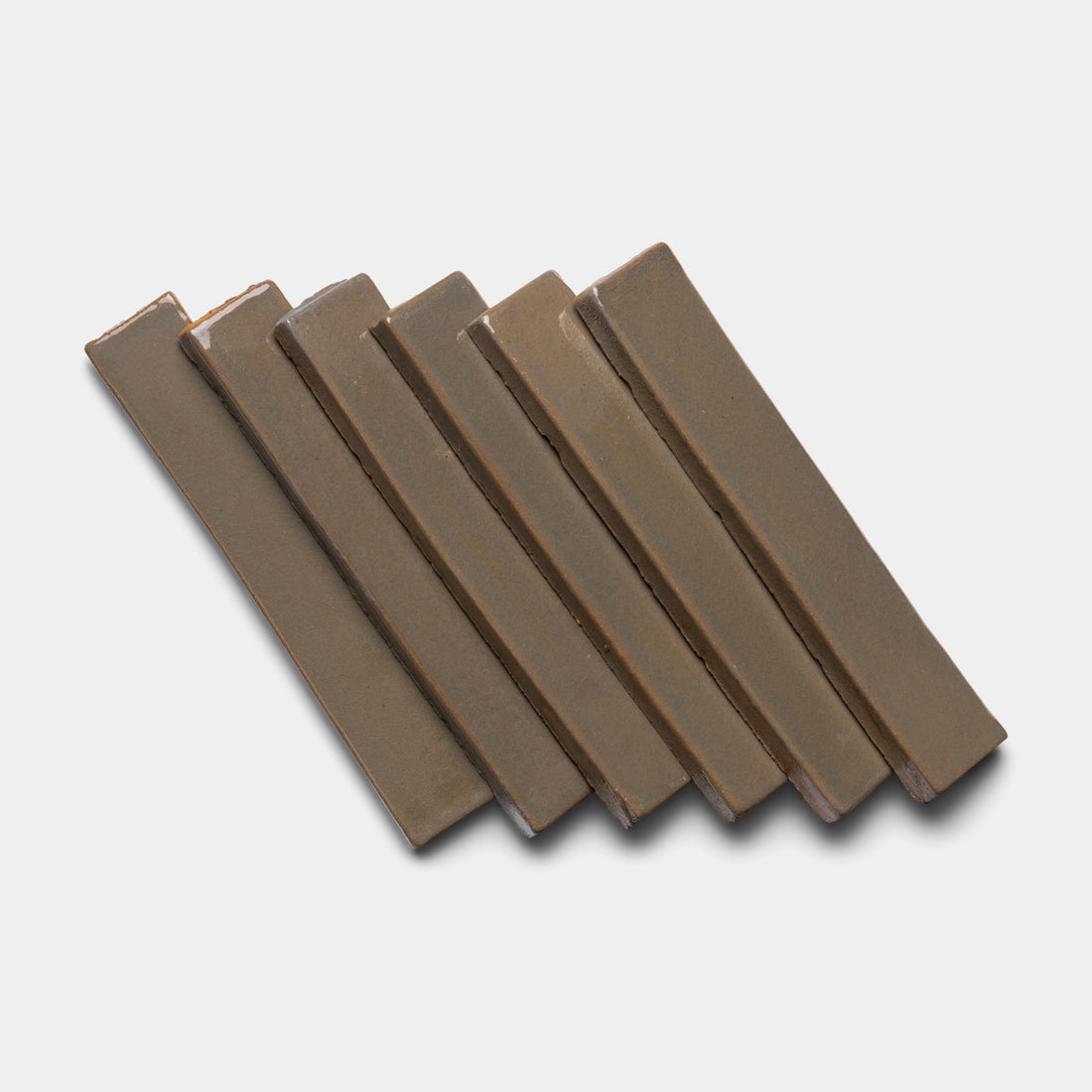 Six rectangular pieces from the Condesa Mini Bar by Zia Tile are arranged in a slightly fanned-out, parallel stack on a light gray background.