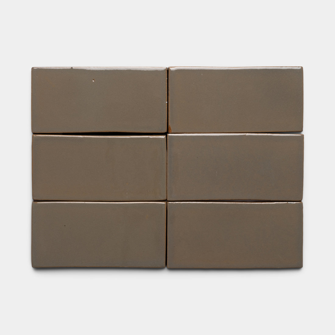 Six glossy Condesa 4x8 Rectangle tiles by Zia Tile, in a rectangular taupe color, are arranged in two rows of three against a plain white background.