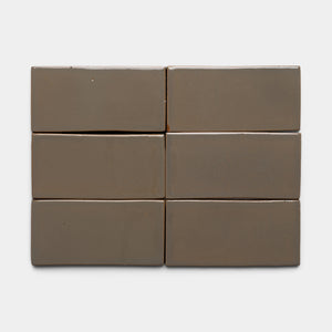 Six glossy Condesa 4x8 Rectangle tiles by Zia Tile, in a rectangular taupe color, are arranged in two rows of three against a plain white background.