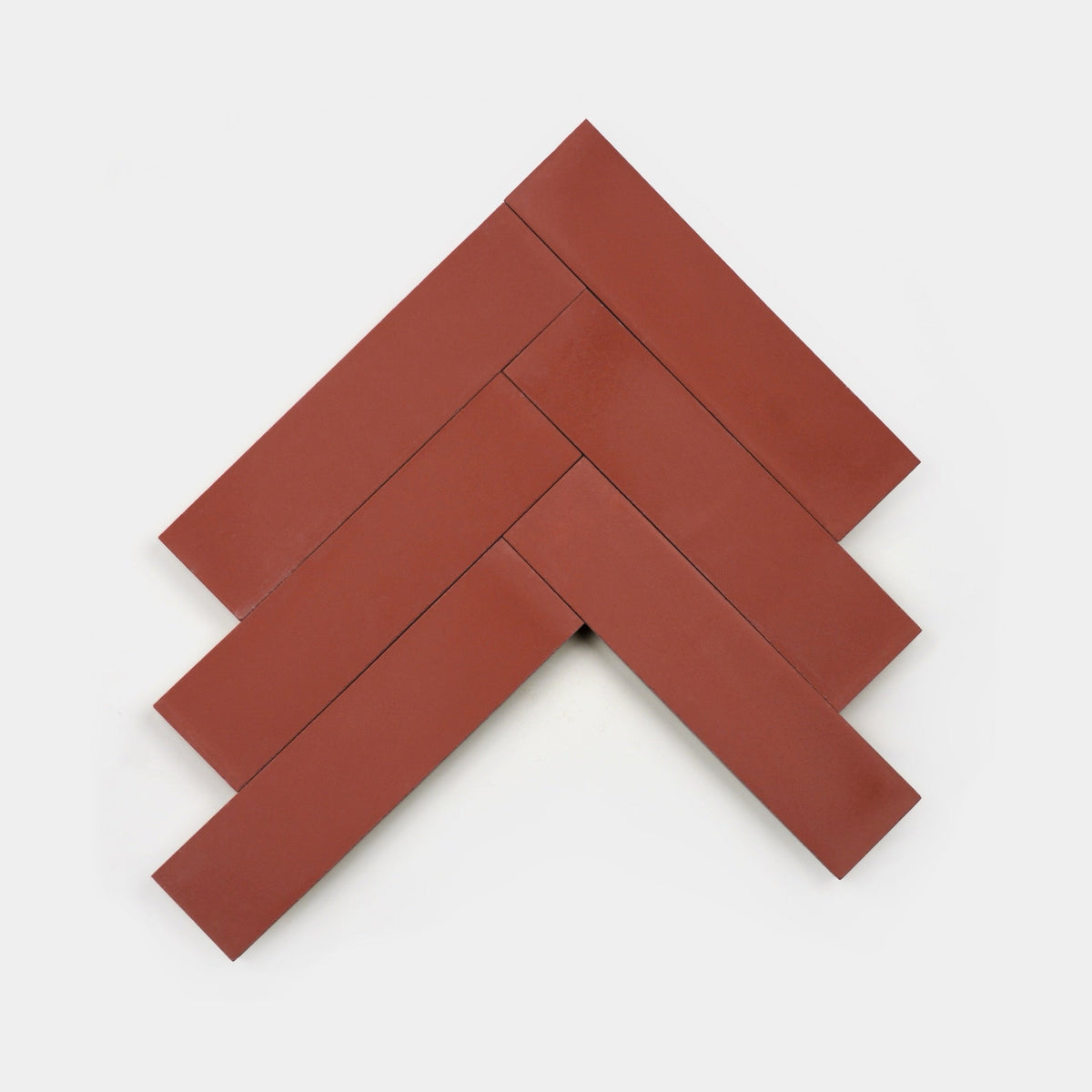 Six Coral 2x8 handmade tiles by vendor-unknown are arranged in a herringbone pattern on a plain white background.