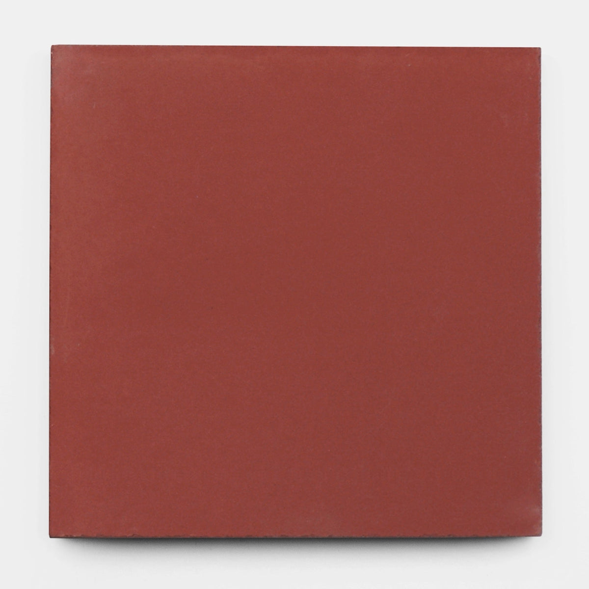 A Coral 8x8 sample tile by vendor-unknown, featuring a plain, square shape and smooth reddish-brown cement surface, shown on a white background.