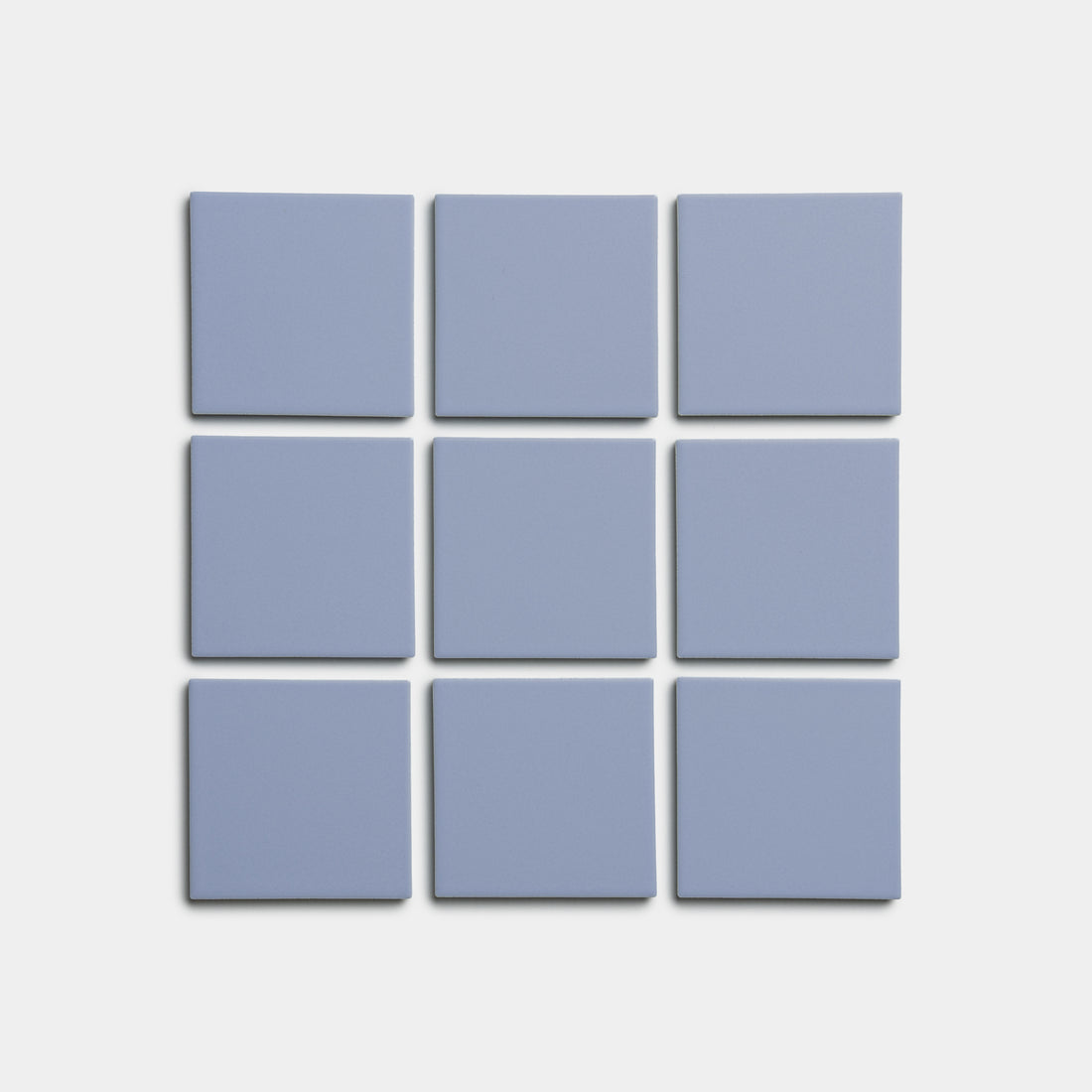 Nine Cornflower 4x4 tiles by Zia Tile, light blue and square, are arranged in a 3x3 grid on a plain white background.