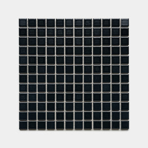 Cosmic Black 1x1 by Zia Tile features a square grid of small, glossy black tiles with thin white grout lines, arranged evenly against a plain light gray background.