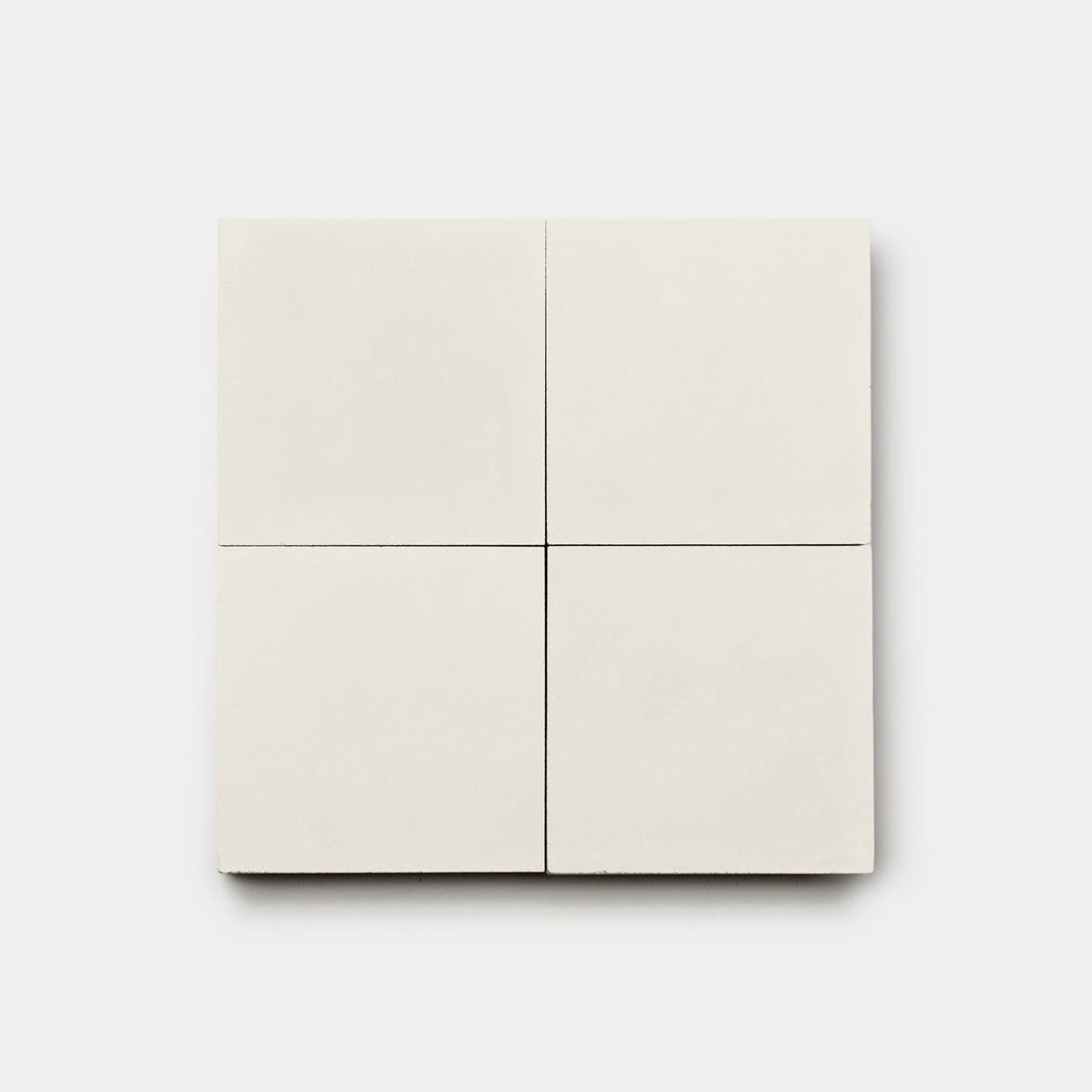 The Cotton 4x4 tiles by vendor-unknown are plain, square, off-white 4x4 tiles shown in a grid on a white background—ideal for classic bathroom floors or minimalist cement tile accents.