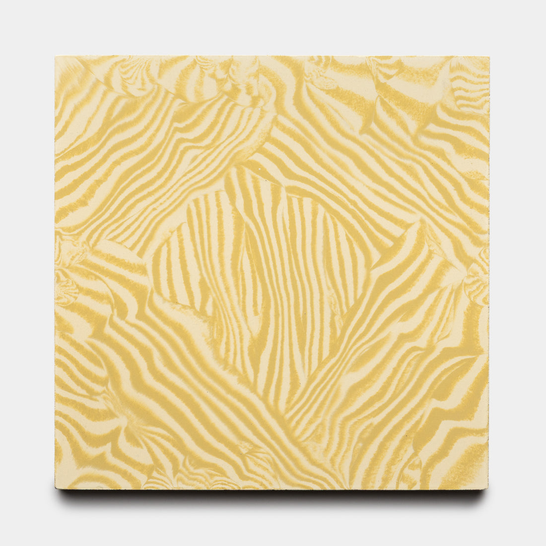 The Currents Mustard + Solar 8x8 tile from Zia Tile features a square shape with a wavy, abstract yellow and white pattern reminiscent of zebra stripes on a plain white background.