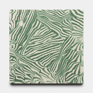 The Currents Noblen Green + Bone 8x8 sample by Zia Tile showcases an abstract, zebra-inspired pattern in green and white, creating a bold, organic texture across the canvas.