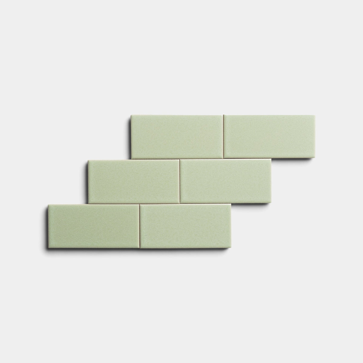 Five Cypress 2x4 light green tiles by Zia Tile are arranged in a staggered, brick-like pattern on a plain white background.