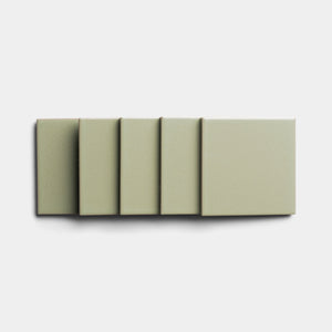 Five matte, square Cypress 4x4 tiles by Zia Tile in muted sage green are arranged in a row on a white background, each slightly overlapping the next to showcase their artisanal charm.