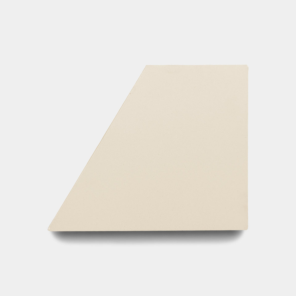 The Derby Ginger + Bone sample by Zia Tile is a beige, flat handmade tile with a geometric trapezoid shape, displayed against a plain white background.