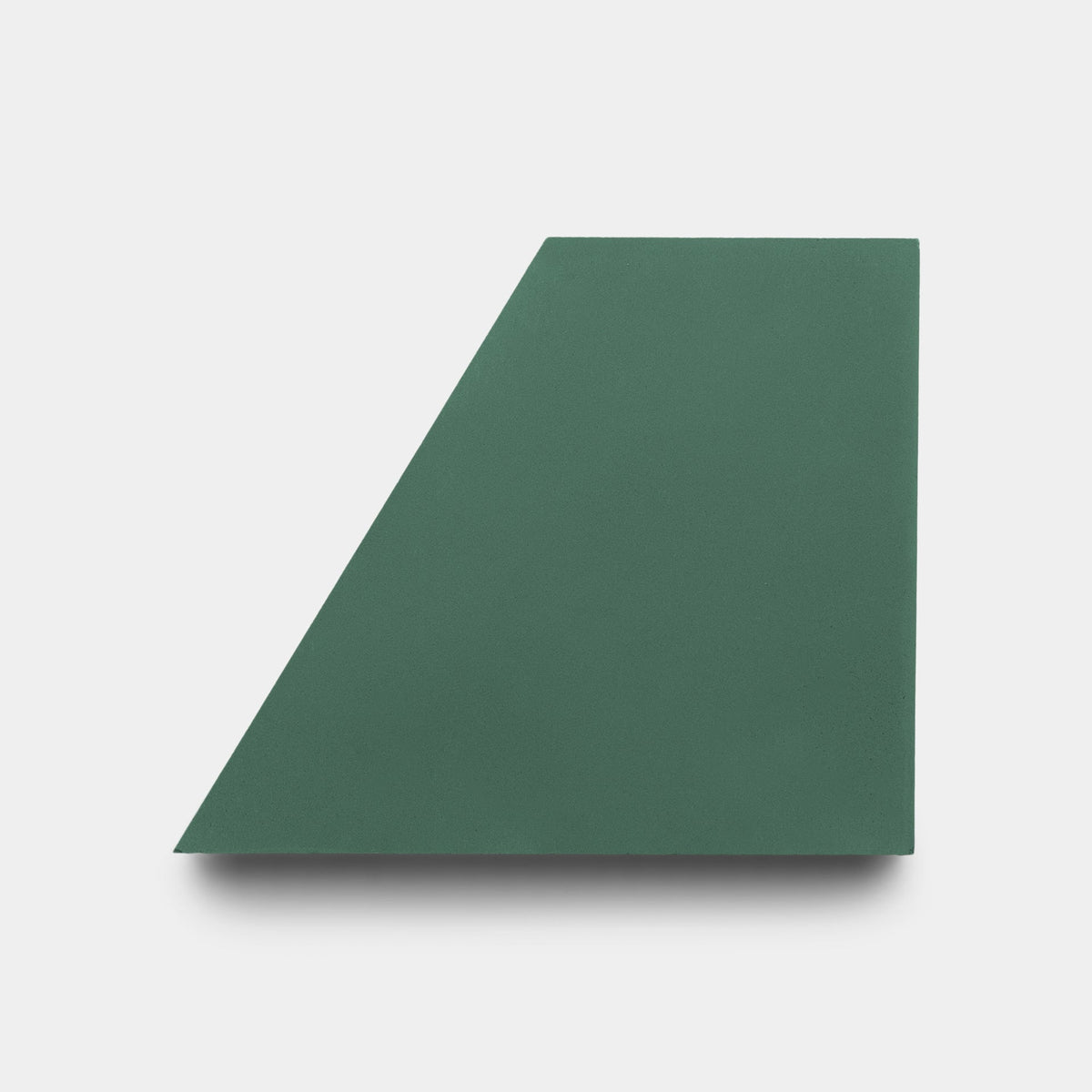 A solid green, four-sided geometric shape, inspired by Zia Tile's Derby Julep + Noble Green Sample, echoes modern elegance against a white background.