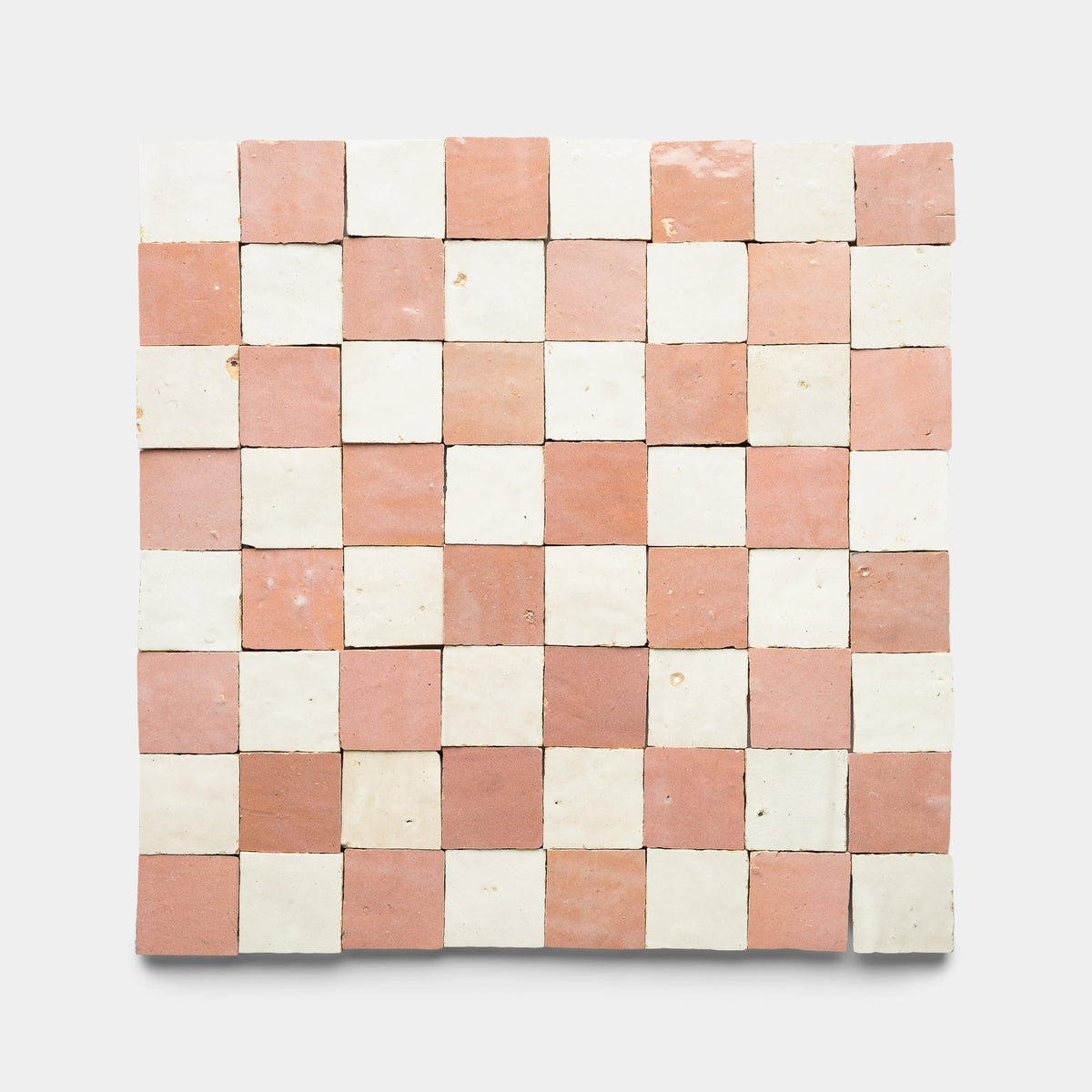The Zia Tile Desert Bloom + Casablanca Checkerboard sample features alternating light pink and off-white handmade square tiles, shown against a plain white background.