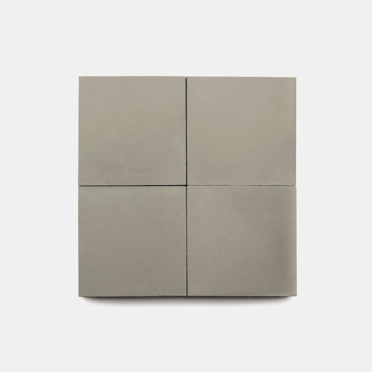 Four square Desert Grey 4x4 tiles by vendor-unknown are arranged in a 2x2 grid on a plain white background, highlighting their modern style.
